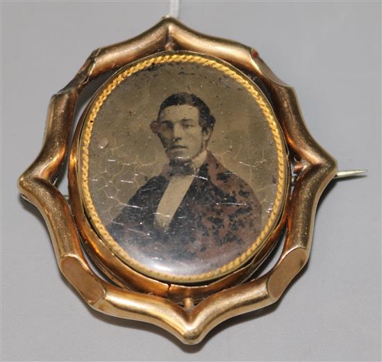 A Victorian carved cameo brooch in gilt metal mount and gold surround with pendant bale, 2.25in.